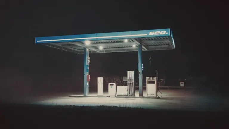 Beleuchtete Tankstelle in der Nacht für einen Artikel über Kraftstoffpreise.